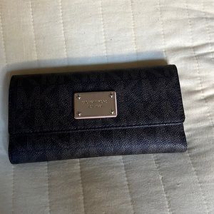 Michael Kors brown wallet. Wear and tear as shown in photos.